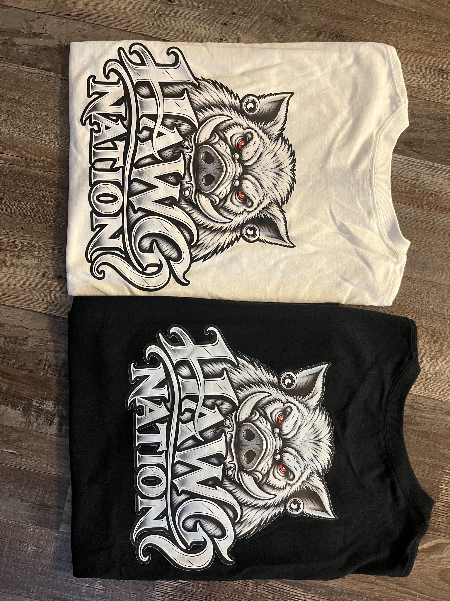 Actual folded black and white Hawg Nation shirts photographed by the brand